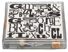 George Brecht (American, 1926–2008). Games and Puzzles (Name Kit) from Fluxkit. 1965, Fluxus Edition announced 1965. Plastic box with two offset labels, containing offset card, ball, rubber object, rubber stamp, stone and three die. Designed and assembled by George Maciunas (American, born Lithuania. 1931–1978). 7/8 x 4 11/16 x 3 15/16" (2.3 x 11.9 x 10 cm) (box, closed). The Gilbert and Lila Silverman Fluxus Collection Gift. © 2011 Artists Rights Society (ARS), New York/VG Bild-Kunst, Germany